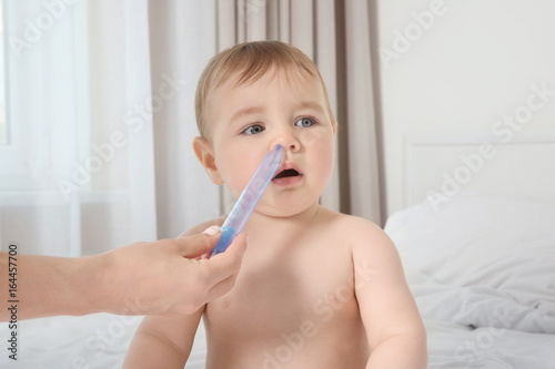 Mother using nasal aspirato...