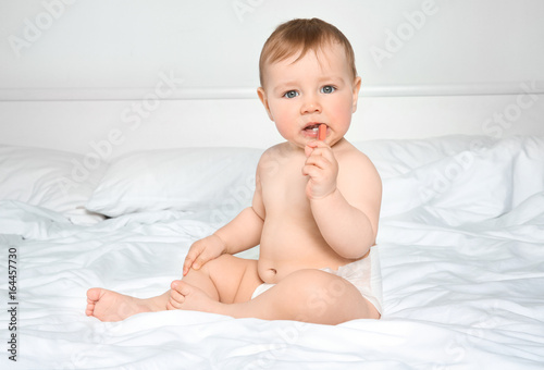 Cute little baby sitting on...