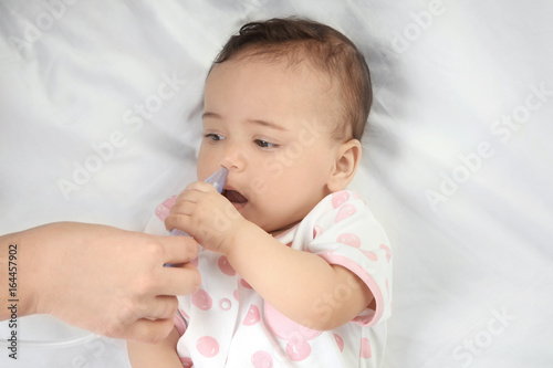 Mother using nasal aspirato...