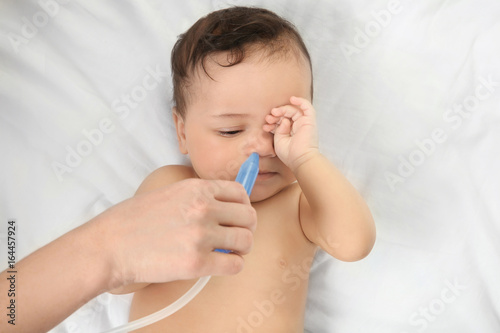 Mother using nasal aspirato...