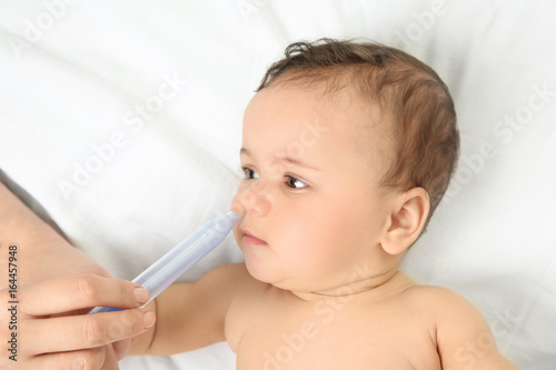Mother using nasal aspirato...