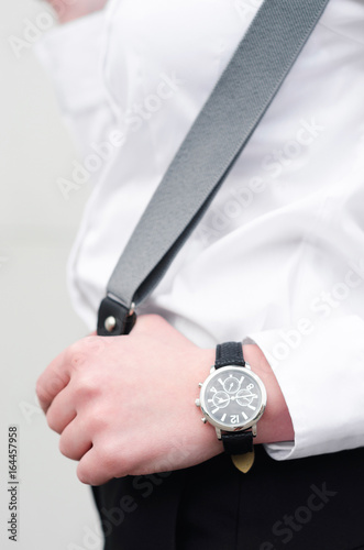 Young women with suspender braces and watch
