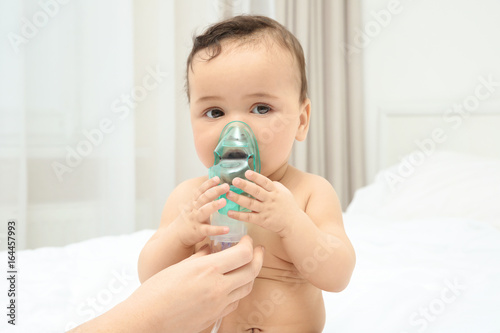 Mother using nebulizer for ...