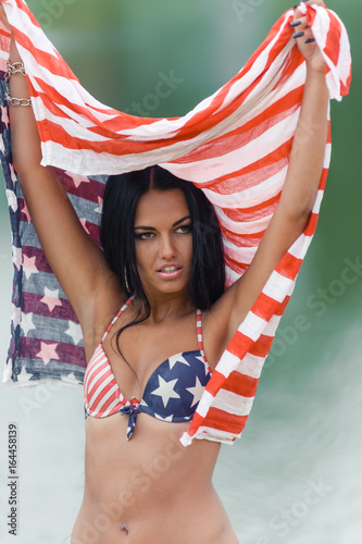 Girl on the beach with american flag