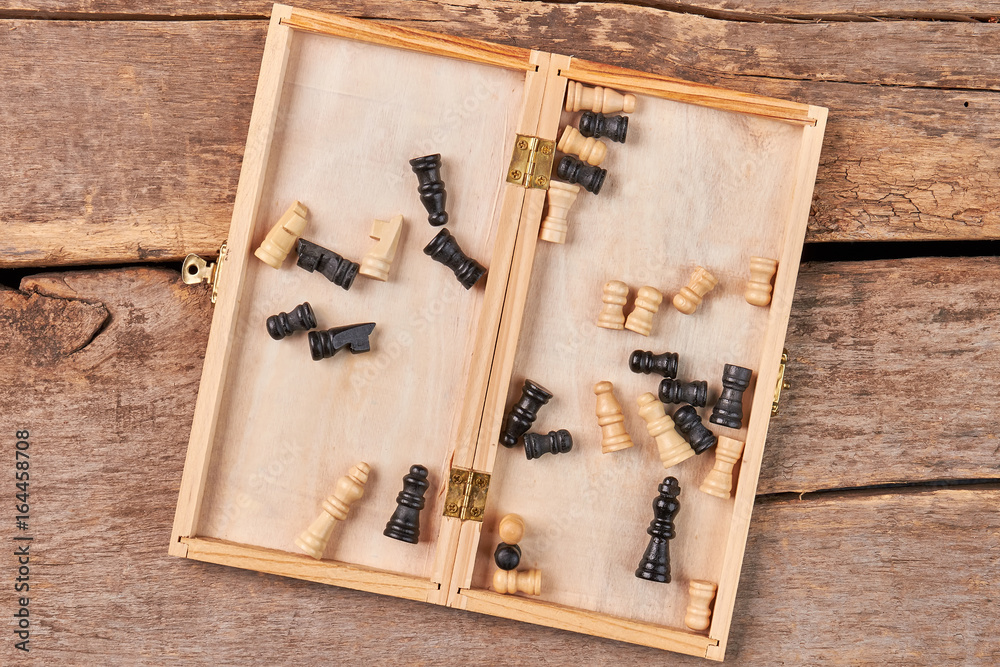 Opened box with checkers.Checkered box with checkers on wooden ...