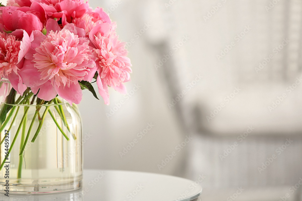 Glass vase with beautiful peonies on table Glass vase with beautiful peonies on table