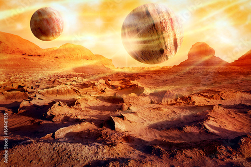 Planets over a lifeless desert. Space landscape in red-yellow tones. Alien planet concept. Artistic image.