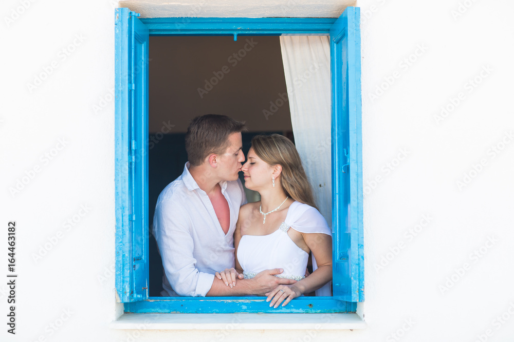 Loving couple in the window Loving couple in the window