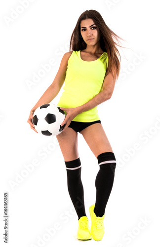 Beautiful young woman with a football