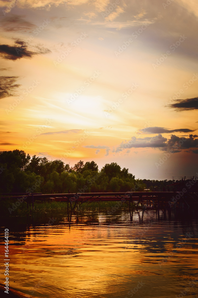 Sunset on the river - a beautiful evening summer landscape. Russia. Vertical photography.