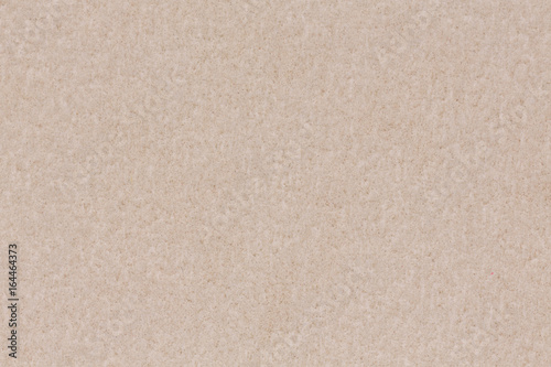 Paper texture light rough textured spotted blank copy space background in beige, yellow, brown.