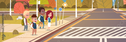 Group Of School Children Waiting For Green Traffic Light To Cross Road On Crosswalk Flat Vector Illustration
