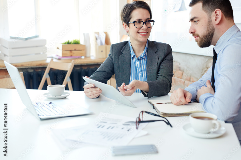 Economists discussing online project by workplace Economists discussing online project by workplace