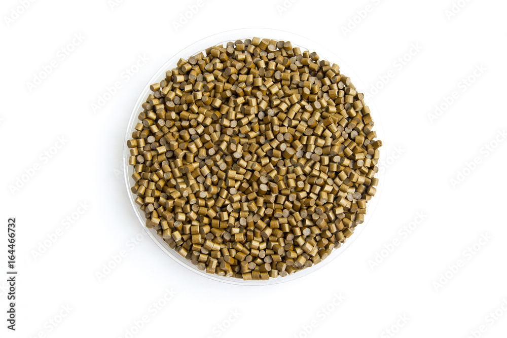 The plastic granules. Dye for polypropylene, polystyrene granules into a measuring container The plastic granules. Dye for polypropylene, polystyrene granules into a measuring container