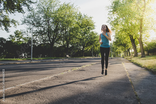 Young woman running, jogging in the park. Exercising outdoor