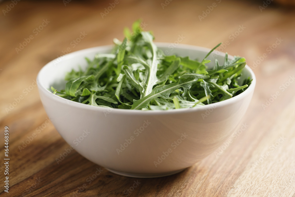 fresh green rocket salad arugula leaves in white bowl fresh green rocket salad arugula leaves in white bowl