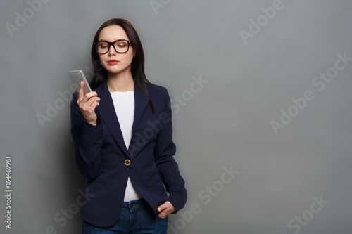 Young caucasian businesswoman calls mobile phone