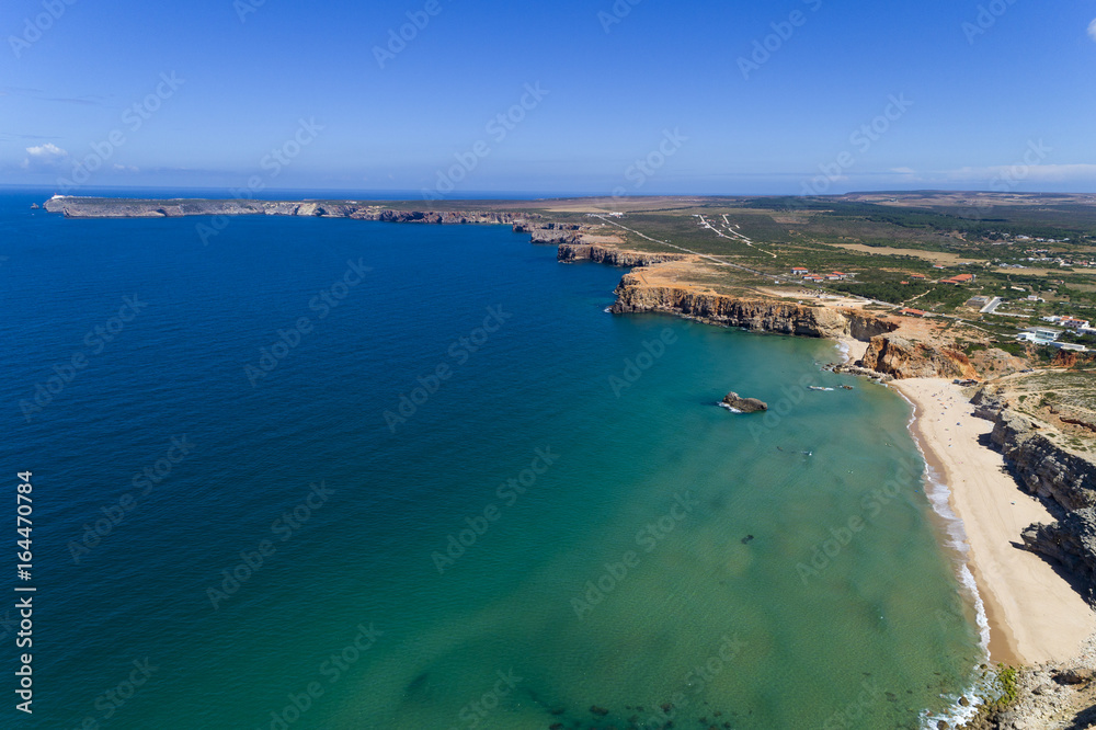 Aerial view of the Tonel Beach (Praia do Tonel) with the Saint Vincent Cape (Cabo de Sao Vincente) on the background, in Algarve, Portugal