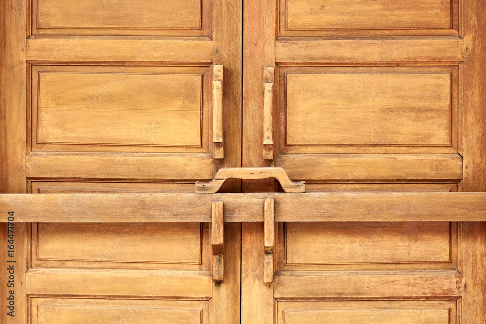 Closed wooden door with ancient locking bar, Traditional wooden door latch  Stock Photo | Adobe Stock