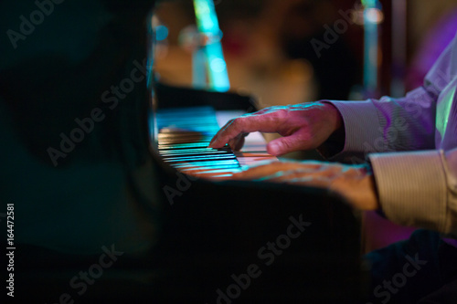 Fototapeta Hand of pianist in jazz cafe - telephoto