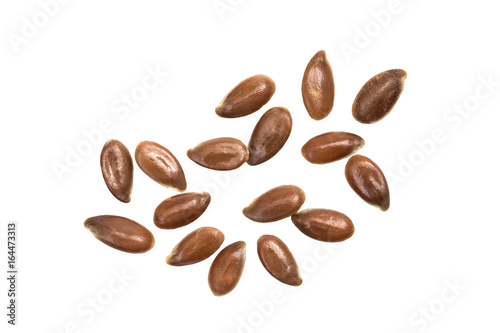 Some linseeds spread out on white background seen from above