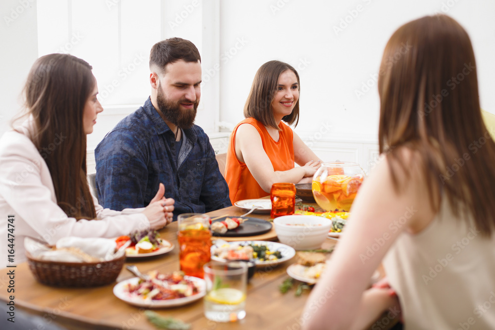 Group of happy people at festive table dinner party Group of happy people at festive table dinner party