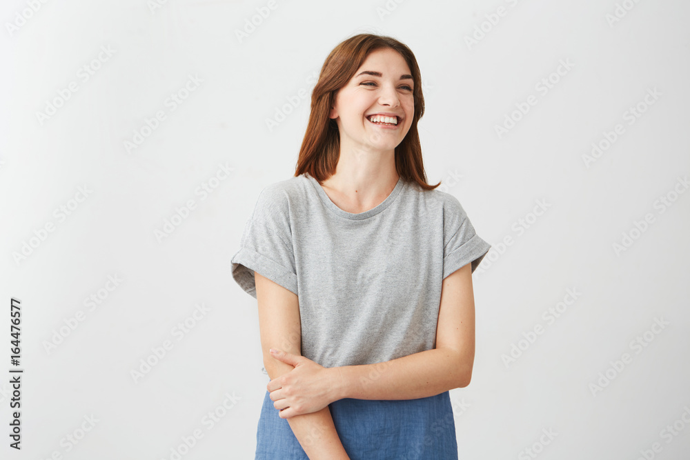 Portrait of sincere young happy cheerful girl smiling laughing over white background. Portrait of sincere young happy cheerful girl smiling laughing over white background.