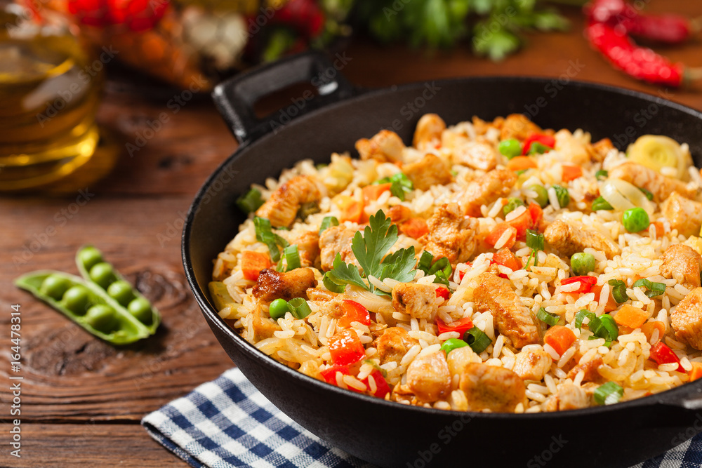 Fried rice with chicken. Prepared and served in a wok.