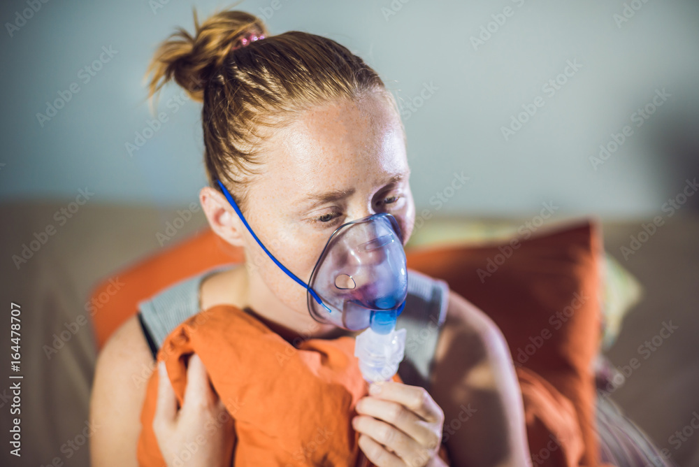 Woman with flu or cold symptoms making inhalation with nebulizer - medical  inhalation therapy Stock Photo | Adobe Stock
