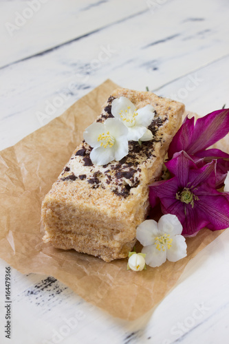 Piece of Napoleon cake decorated flowers.Beautiful dessert.Homemade bakkery,custard creame photo