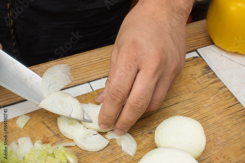 Onion cutting on a wooden cutting board