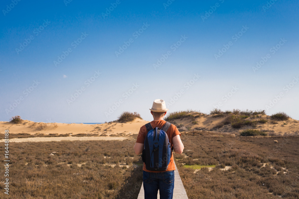 Outdoors lifestyle image of travelling man back view. Tourism concept.
