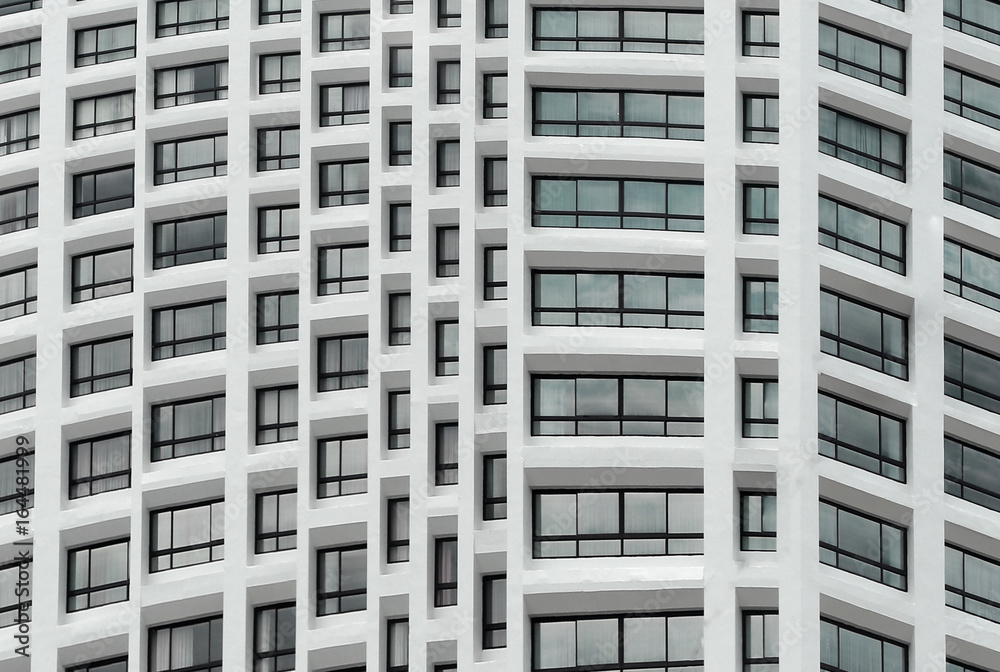 Photo of white building all rooms have windows made from glass. Photo of white building all rooms have windows made from glass.