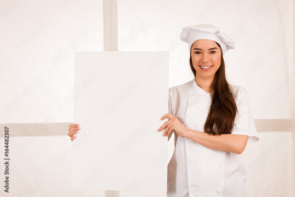 young blonde chef woamn holds kitchenware as she prepares to cook a meal isolated over white background young blonde chef woamn holds kitchenware as she prepares to cook a meal isolated over white background