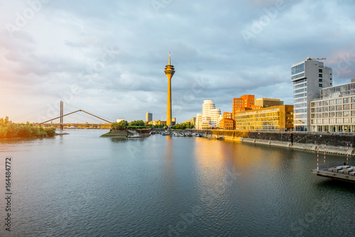Sunset cityscape view on the modern district with Rhein river, beautiful buildings and television tower in Dusseldorf city in Germany