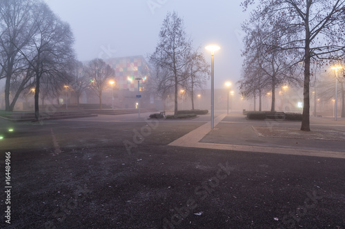 A plaza in the Petite France district of Strasbourg, France on a foggy winter morning at dawn.