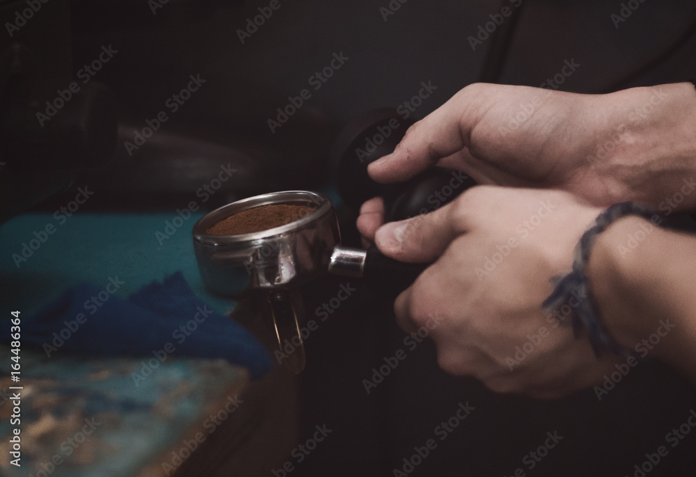 A man is making coffee in a coffee machine A man is making coffee in a coffee machine