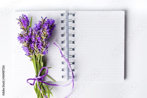 Fototapeta Naklejka Na Ścianę i Meble -  Lavender flowers bouquet on open notebook