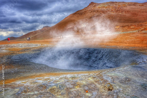 Hot Mud Pots and blue lake in the Geothermal Area Hverir, Iceland