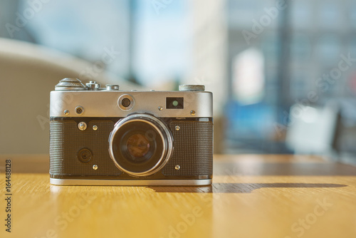 life style background of old film camera at sunny day on cafe table © Andrey Cherlat