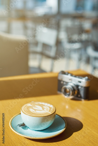 drink background of morning coffey in cafe at sunny day with analog camera on table