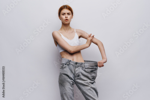Beautiful young woman on a light background, losing weight, sports, diet © SHOTPRIME STUDIO
