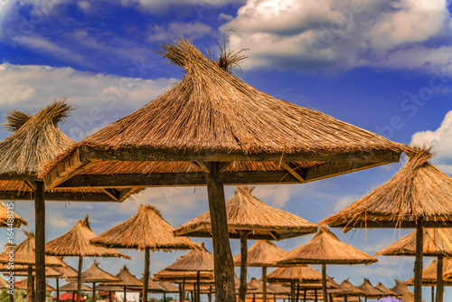 Fototapeta Naklejka Na Ścianę i Meble -  Beach sea straw umbrella