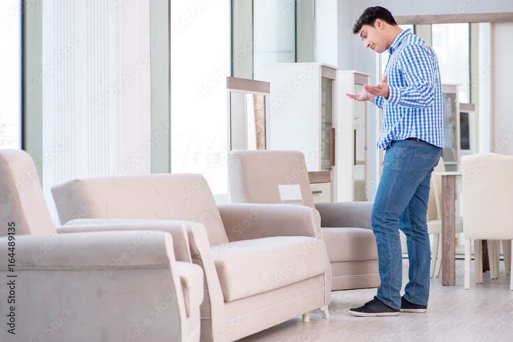 Young man shopping in furniture store Young man shopping in furniture store