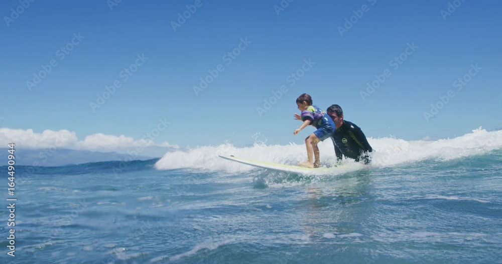 Father teaching son to surf tandem surfing Father teaching son to surf tandem surfing