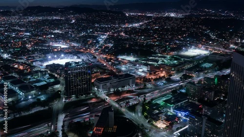 Aerial Time Lapse of Los Angeles Downtown Skyscrapers and Traffic at Night photo