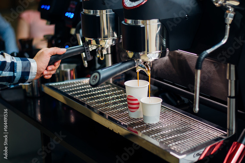 The barman changes the streamer to a coffee machine for making coffee.Preparation and service concept, close-up.