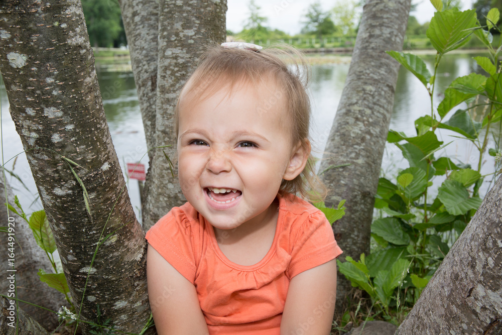 Happy cute little girl on the grass in the park. Happiness Happy cute little girl on the grass in the park. Happiness
