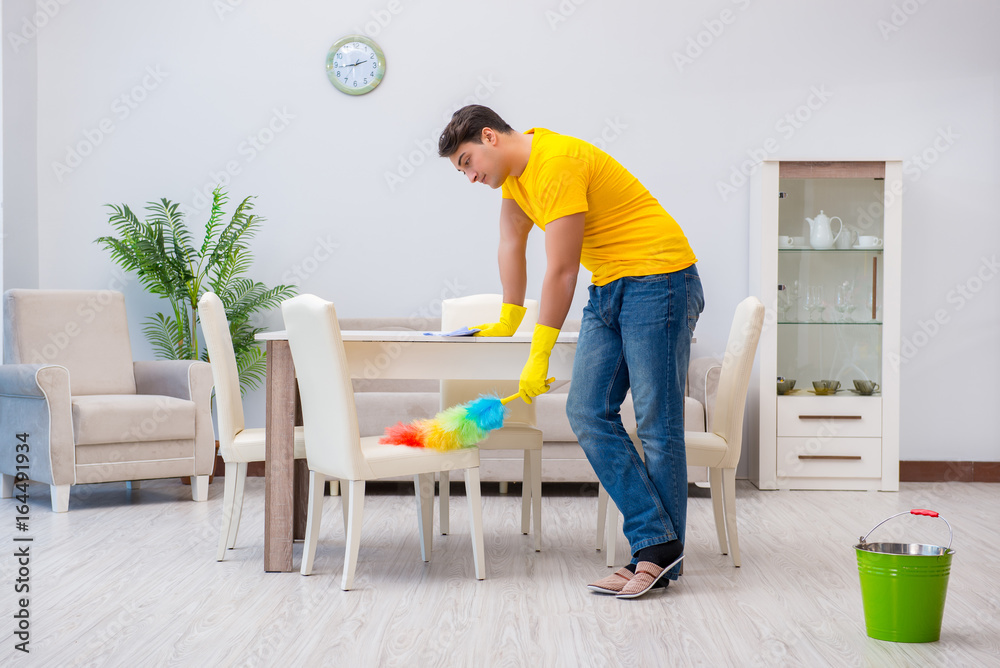 Young man doing chores at home