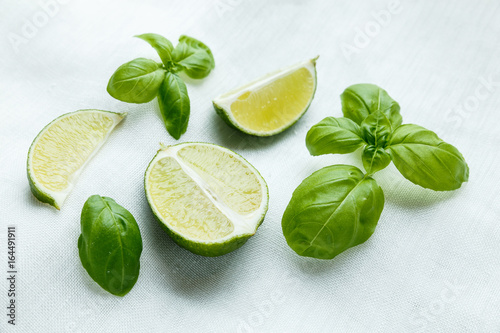 Fresh basil and lime on white background